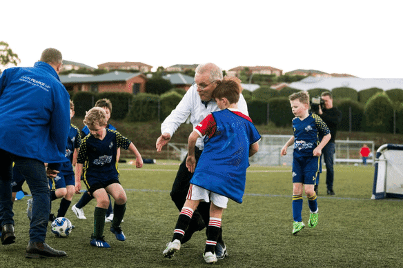 Scott Morrison trips into Luca Fauvette at the Devonport Strikers Soccer Club in the seat of Braddon in 2022.