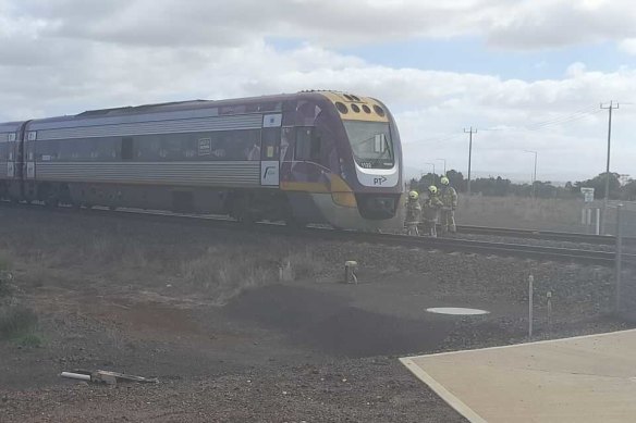 Emergency services inspect a train that was involved in the collision near Rockbank on Monday morning.