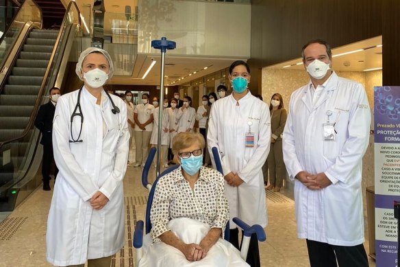 Brazilian Gina Dal Colleto, 97, the oldest known survivor of COVID-19 in Brazil, is pushed in a wheelchair out of Sao Paulo's Vila Nova Star hospital to applause from doctors and nurses on April 12.