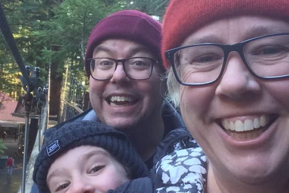 Maher Mughrabi, Heather Shipp and their son wear beanies on an aerial walk in New Zealand in 2019. 