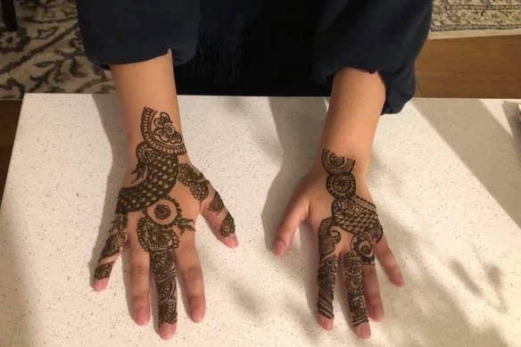 Ahelee Rahman with henna-decorated hands for Eid.