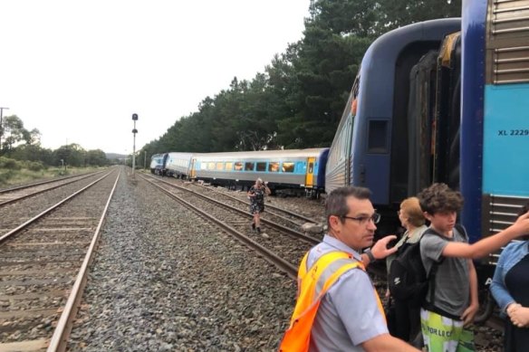 Passengers being helped off the train after it crashed in February 2020.