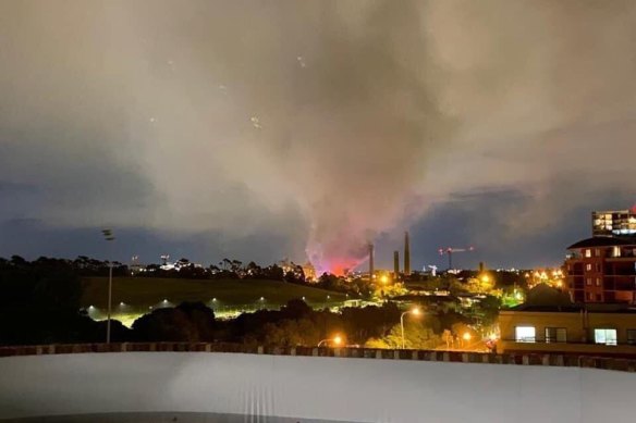 Smoke spreads over Sydney Park after a fire broke out at a motorcycle repair store in St Peters.