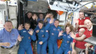 Astronauts wave after the SpaceX capsule docked with the ISS. Butch Wilmore is bottom far left and Suni Williams is top right.