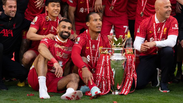 Liverpool's Wataru Endo, Mohamed Salah, Virgil van Dijk, and Arne Slot hold the Premier League Trophy as they celebrate Liverpool being crowned the Champions of the Premier League for the 2024/25 Season following the Premier League match between Liverpool FC and Crystal Palace FC at Anfield in Liverpool, England, on May 25, 2025