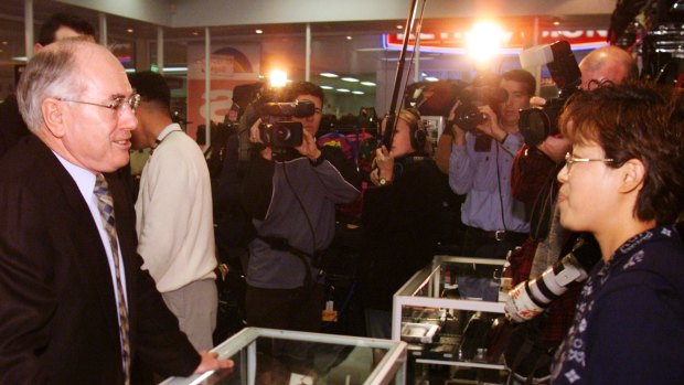 PM John Howard tours the Macquarie shopping centre on the first day of GST introduction. July 1, 2000