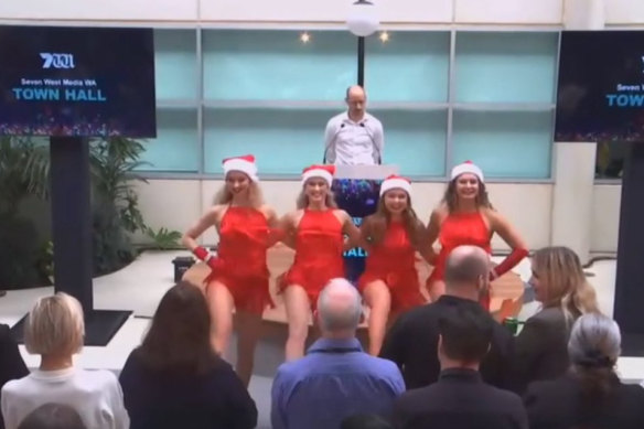 7News Perth news director Ray Kuka addresses staff behind four women dressed up as “sexy Santas”.