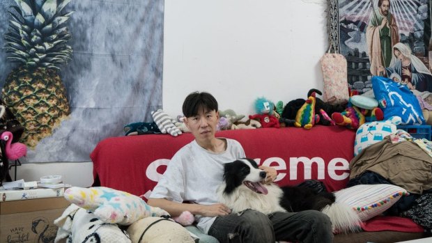Zhou, 31, sits on the couch in his bedroom with 4 ½ -year-old Sylar.
