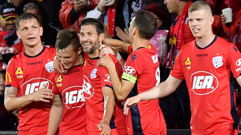 Long-range strike: Scott Galloway celebrates his goal with Reds teammates.