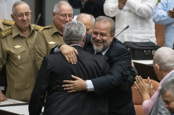 Cuban Prime Minister Manuel Marrero Cruz embraces Cuba's President Miguel Diaz-Canel at the National Assembly of Popular Power in Havana, Cuba.