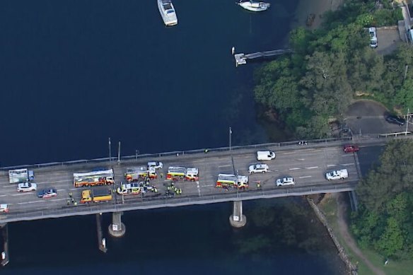 A man has been taken to hospital after his car and a truck collided  on the Spit Bridge, causing widespread traffic delays in Sydney’s north.