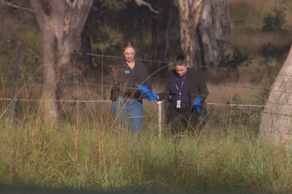 Police search the property where the boys’ bodies were found.