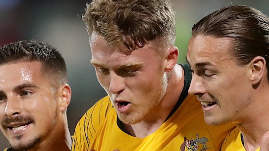 Goal-scorer Harry Souter, centre, with Socceroo teammates in 2019.