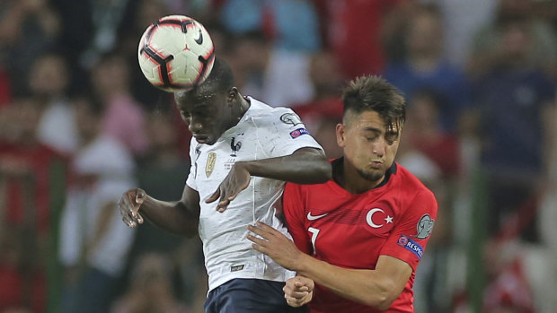 Turkey's Cengiz Under goes head-to-head with France's Ferland Mendy.
