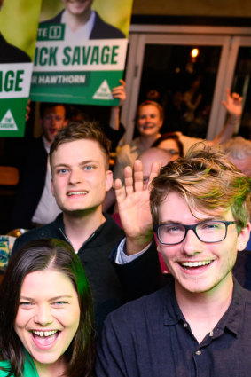 Benjamin Chesler behind Greens candidates Nick Savage (Hawthorn) and Jackie Carter (Kew) at a campaign launch last month.