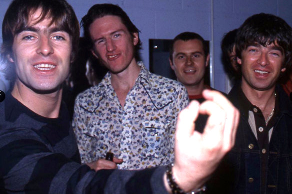 You Am I frontman Tim Rogers (second from left) with Liam Gallagher (left) and Noel Gallagher (far right) of Oasis, on tour together in 1998. 