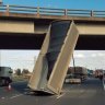 Truck comes off second best after driver hits bridge with raised trailer