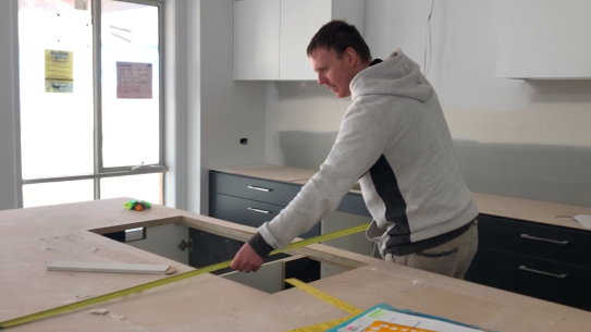 Joel Goldby measuring a bench.