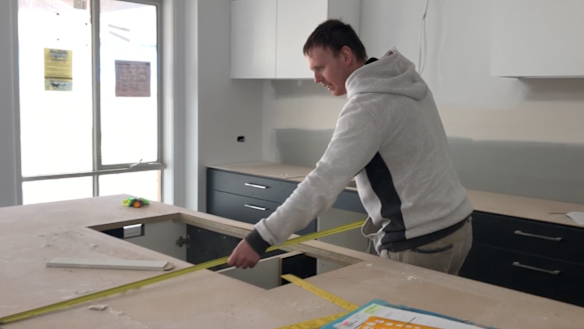 Joel Goldby measuring a bench.