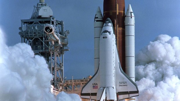 The Shuttle Discovery lifts off  in 1990, carrying a crew of five and the Hubble Space Telescope.  