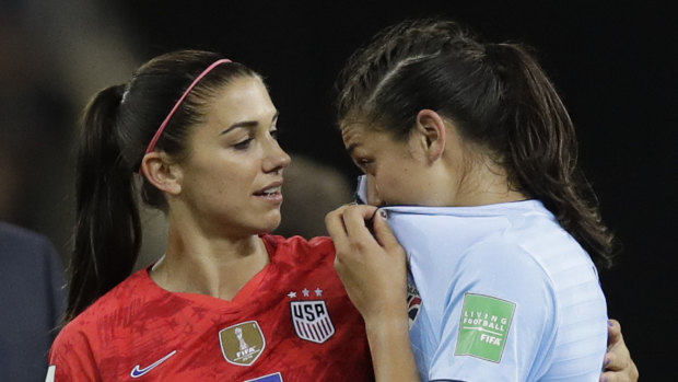 The United States' Alex Morgan comforts Thailand's Miranda Nild after the match.