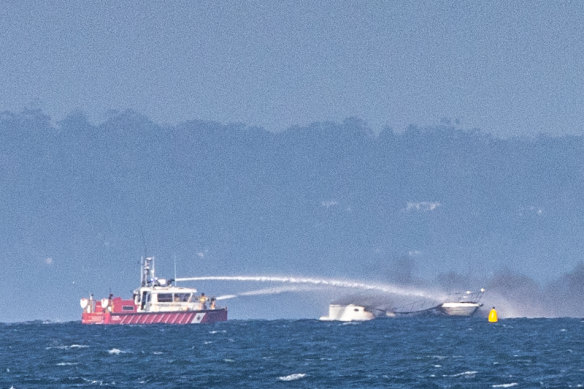 Firefighters battle the boat fire in Port Phillip Bay.