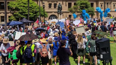 Students descend on Queensland Parliament, rallying for action on climate change.
