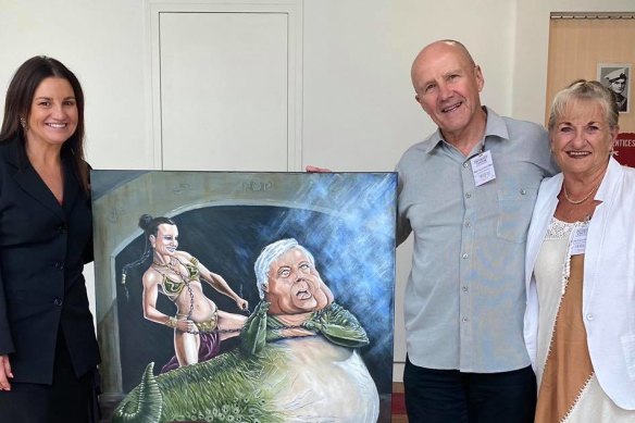 Senator Jacqui Lambie in her office with the Bald Archy portrait depicting her as Princess Leia and Clive Palmer as Jabba the Hutt, which was dropped off by owners Ray and Elain.
