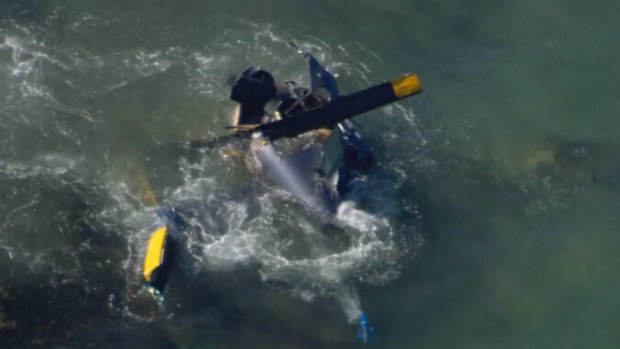 Three people were rescued after their helicopter plunged into the ocean.