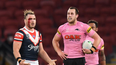 A bloodied Angus Crichton looks on during a break in play.