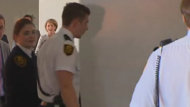 A whiteboard is used to screen Michaelia Cash as she enters a committee room at Parliament House.