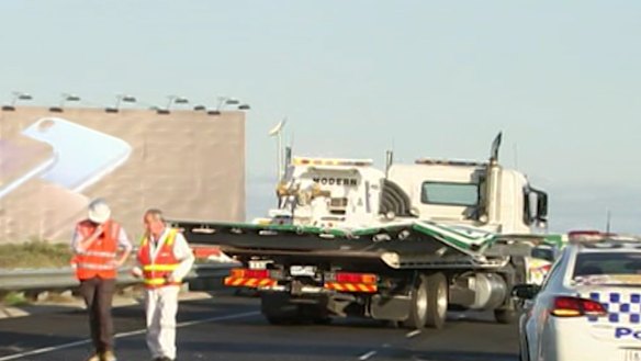 Sign fall: Tullamarine Freeway sign falls and crushes car, injuring woman