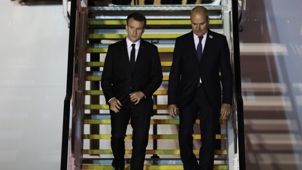 Emmanuel Macron (left) is greeted by French Ambassador Christophe Penot after arriving in Sydney on Tuesday evening.