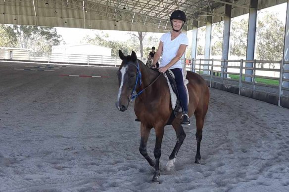 Cathy on her horse who, like many pets, is getting some extra care and attention.