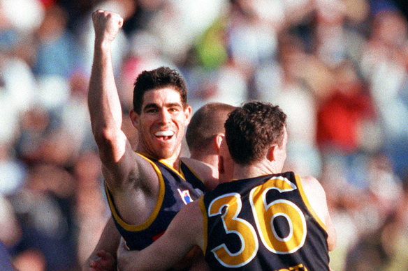 Darren Jarman celebrates with teammates after the preliminary final win over the Bulldogs.