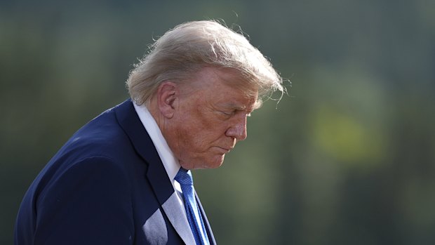 US President Donald Trump walks away following the group photograph at the G7 Summit in Alberta.