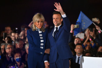 Brigitte Macron wore custom-made cropped Louis Vuitton navy jacket with silver military detailing and matching pants to her husband’s re-election night.  