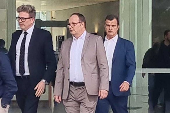 Mark Sheridan Waden (centre) leaves court with his legal team James Godbolt (right) and Nick Dore (left).