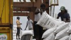 Workers pile sacks of fertilizer imported from India onto a truck at the Port of Colombo. 