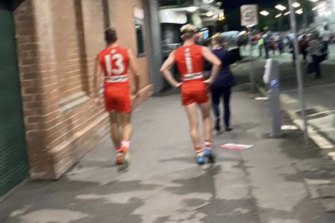 Ollie Florent and Chad Warner on Driver Avenue walking to the change rooms after the ‘Buddy’ Franklin 1000th goal ground invasion.