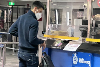Novak Djokovic presents his travel papers after arriving at Melbourne Airport  on Wednesday evening.