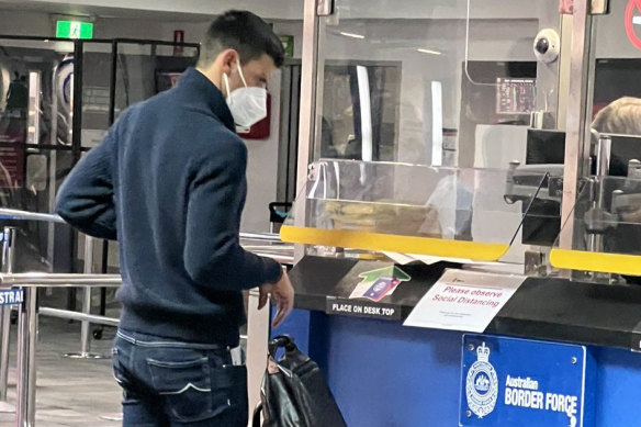 Novak Djokovic presents his travel papers after arriving at Melbourne Airport  on Wednesday evening.