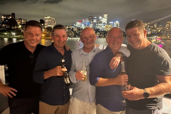 Ben Fordham (left) and Phil “Buzz” Rothfield (centre) celebrate on a harbour cruise.
