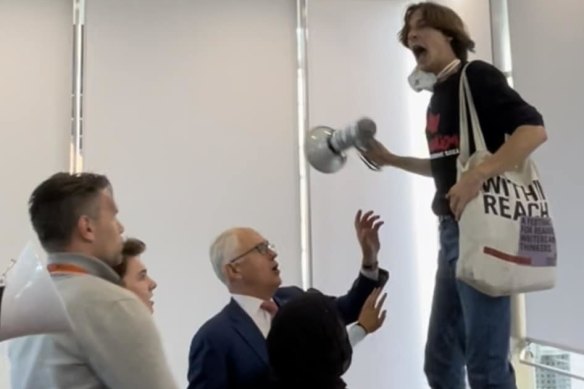 Deaglan Godwin protests Malcolm Turnbull at a Sydney University Law Society event in September 2022.
