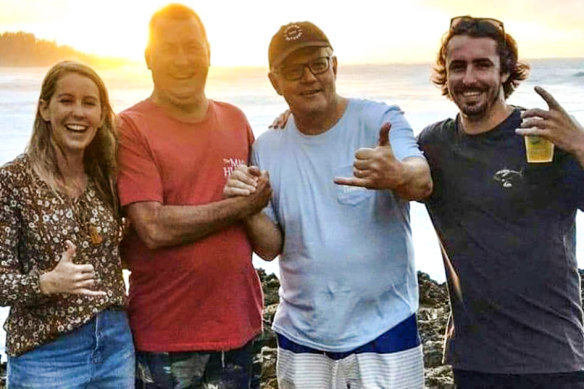 Scott Morrison on holiday in Hawaii during the Black Summer bushfires poses for a photo with a group of Australian tourists.