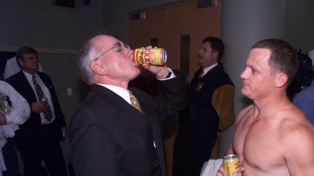 John Howard downing a tinny with Brisbane Broncos player Kevin Walters after their grand final win in 1998.