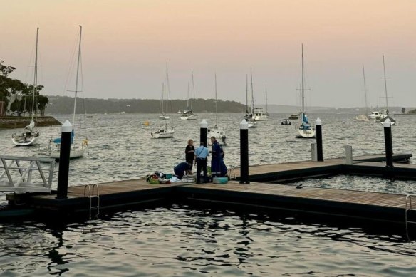 Emergency personnel attend to the woman who was attacked by a shark.