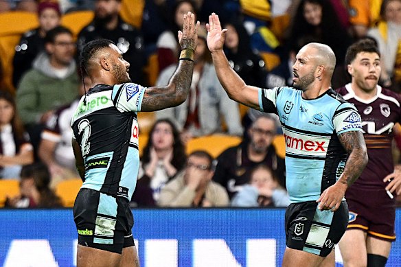 Sione Katoa and Braydon Trindall celebrate Cronulla's win.