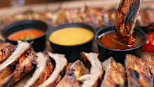 Stock image of someone eating ribs in a restaurant