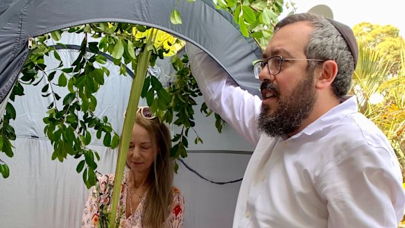 Nikki Goldstein and Rabbi Eli Schlanger at Goldstein’s home to help her observe Sukkot, a Jewish festival commemorating God’s protection of the Israelites during their 40 years of wandering in the desert. 